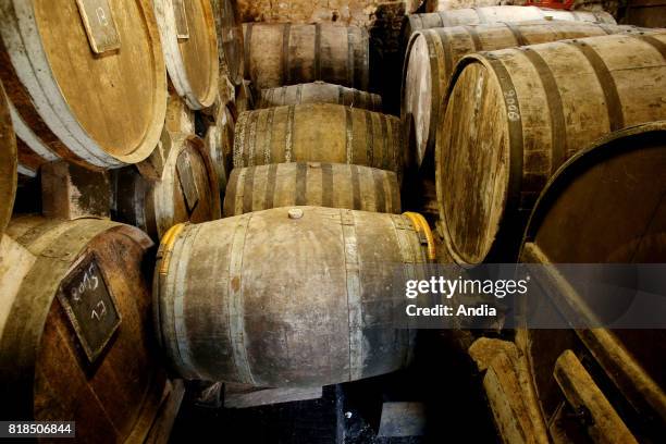 Domfront AOC pear cider and Calvados produced by Frederic Pacory at the farm 'ferme des Grimaux' in Mantilly, in the Orne department. Casks of...