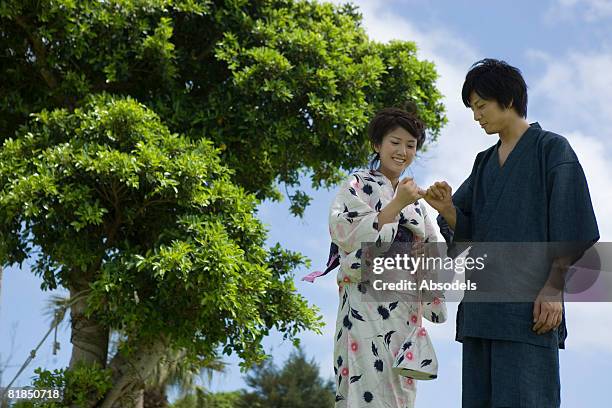 young couple making promise together - pinky promise stock pictures, royalty-free photos & images