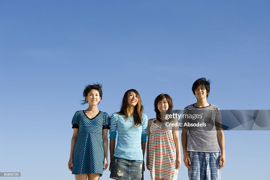 Four people standing side by side