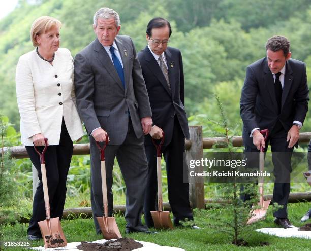 German Chancellor Angela Merkel, U.S. President George W. Bush, Japanese Prime Minister Yasuo Fukuda and French President Nicolas Sarkozy plant the...