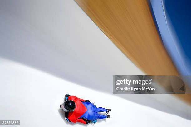 Model Released Bobsled/Skeleton: Woman on skeleton sled racing down ice track at Utah Olympic Park, Utah.