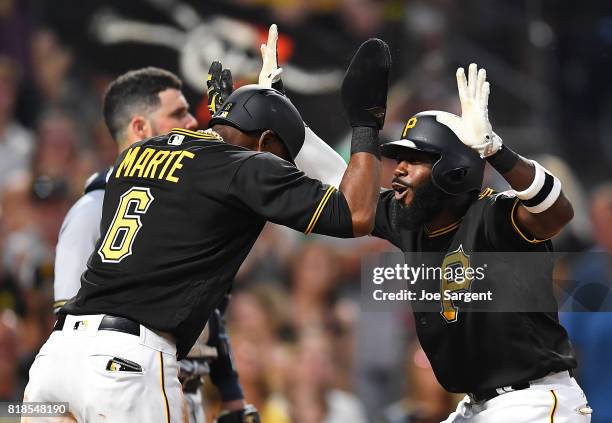 Josh Harrison of the Pittsburgh Pirates celebrates his two run home run with Starling Marte during the sixth inning against the Milwaukee Brewers at...