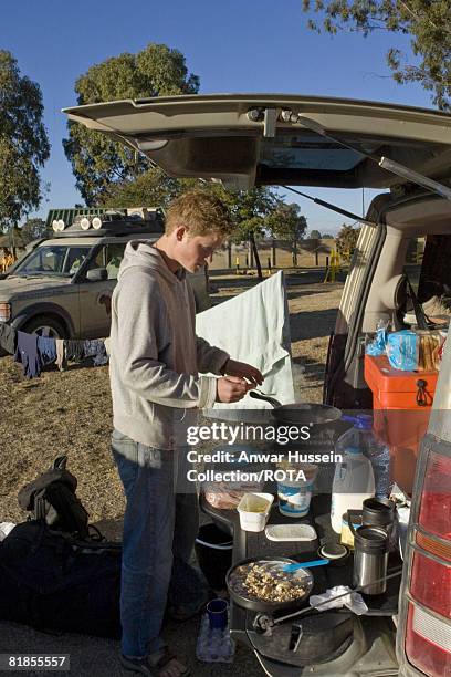 SOUTH AFRICA Prince Harry prepares food during an expedition with the Household Cavalry on July 5, 2008 in Blomfontein, South Africa. The young royal...