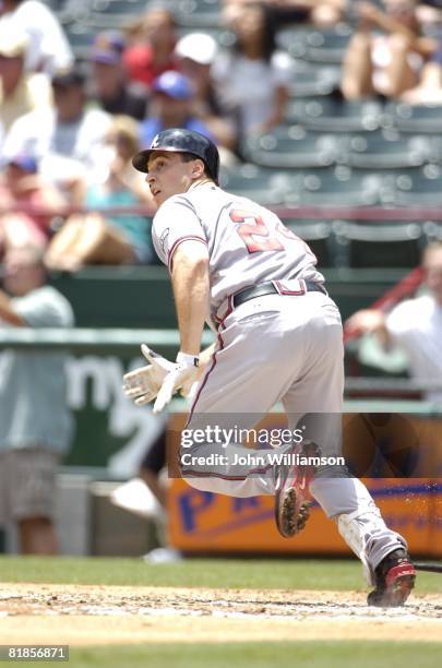 Designated hitter Mark Teixeira of the Atlanta Braves runs to first base after hitting the ball during the game against the Texas Rangers at Rangers...