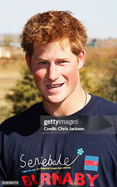 Prince Harry laughs as he helps rebuild a school on July 8, 2008 in Buthe Buthe, Lesotho. Prince Harry and 26 soldiers from the Household Cavalry are...