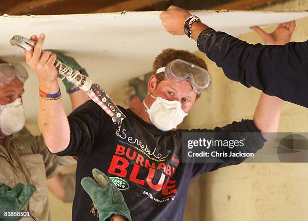 Prince Harry helps rebuild a school on July 8, 2008 in Buthe Buthe, Lesotho. Prince Harry and 26 soldiers from the Household Cavalry are in Lesotho...