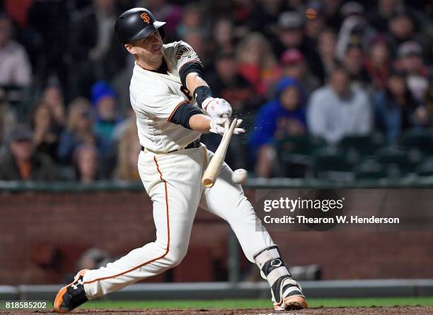 Buster Posey of the San Francisco Giants breaks his bat hitting an rbi single scoring Eduardo Nunez against the Cleveland Indians in the bottom of...