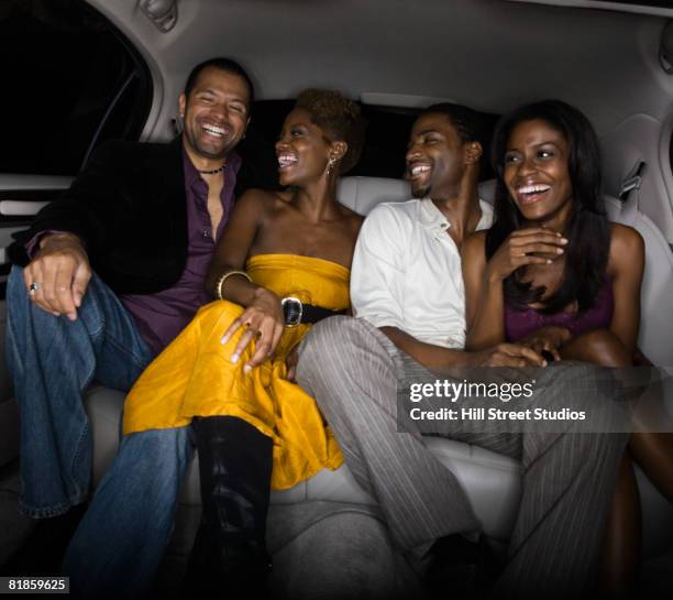 multi-ethnic friends in back of limousine - double date stock pictures, royalty-free photos & images