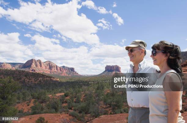 multi-ethnic senior couple looking at desert landscape - sightseeing in sedona stock pictures, royalty-free photos & images