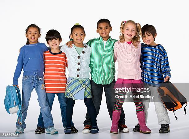 multi-ethnic children hugging - indian boy standing stock pictures, royalty-free photos & images