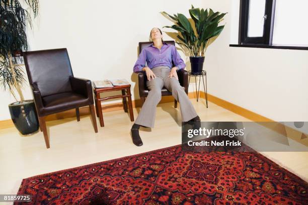 mixed race woman sitting in waiting area - impatient stock pictures, royalty-free photos & images