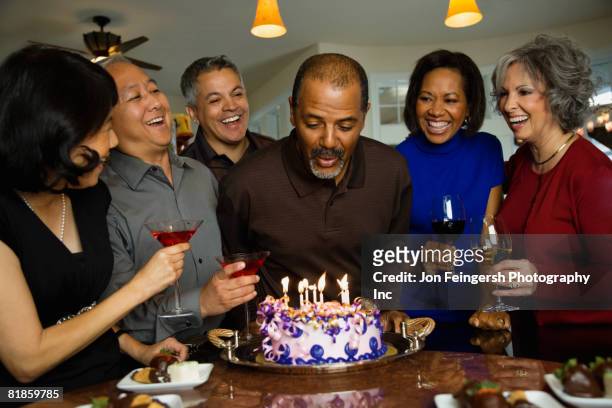 african man celebrating birthday with multi-ethnic friends - attendee stock pictures, royalty-free photos & images