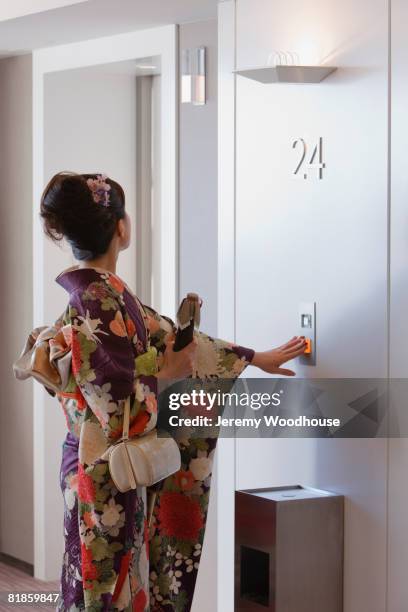 asian woman pressing elevator button - pressing elevator button stock pictures, royalty-free photos & images