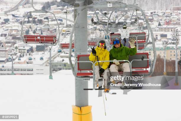 asian couple sitting on ski lift - woman on ski lift stock pictures, royalty-free photos & images