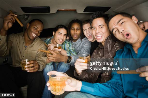 multi-ethnic men celebrating in limousine - 男性告別單身派對 個照片及圖片檔