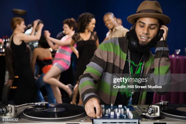 african male dj playing music - headphones turntable stock-fotos und bilder