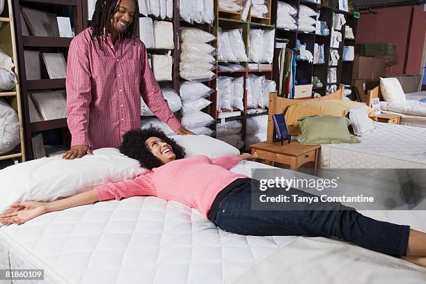 african couple shopping for beds - furniture shopping stock pictures, royalty-free photos & images