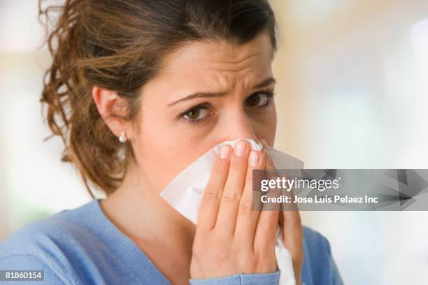 woman blowing nose - covering nose stock pictures, royalty-free photos & images