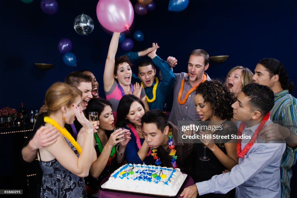 Asian man celebrating birthday with friends