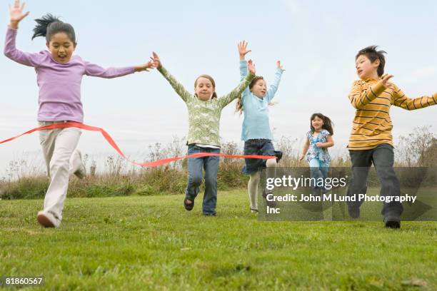 multi-ethnic children running race - 子供のみ ストックフォトと画像