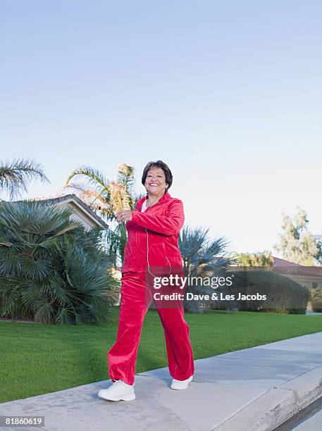 senior hispanic woman exercising - tracksuit stock pictures, royalty-free photos & images