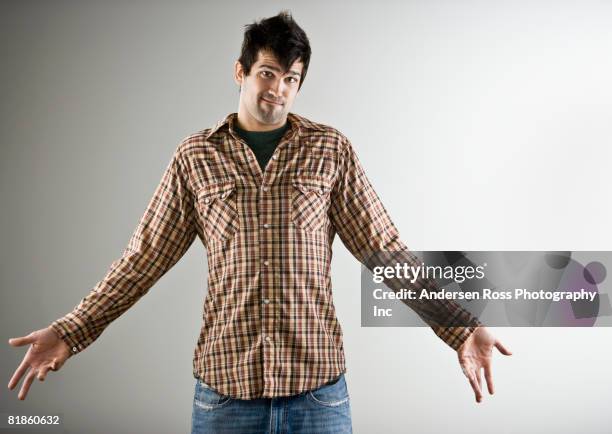 native american man shrugging shoulders - shrugging stock pictures, royalty-free photos & images