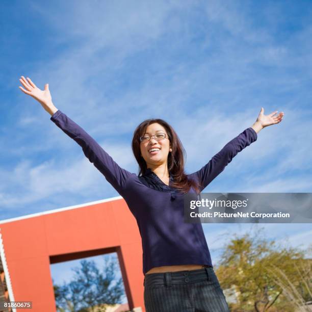 asian woman with arms raised - henderson   nevada stock pictures, royalty-free photos & images