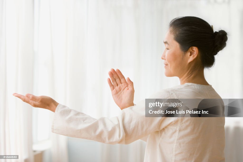 Asian woman practicing tai chi