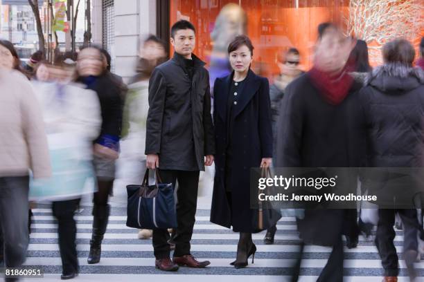 asian businesspeople standing in crowd - business man in crowd stock pictures, royalty-free photos & images