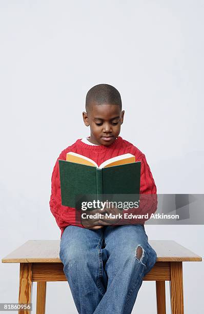 african boy reading book - blank book on desk photos et images de collection