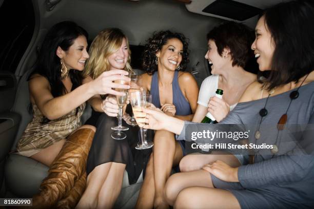 multi-ethnic women toasting with champagne - addio al nubilato foto e immagini stock