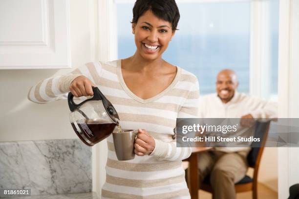 african woman pouring coffee - coffee pot stock pictures, royalty-free photos & images