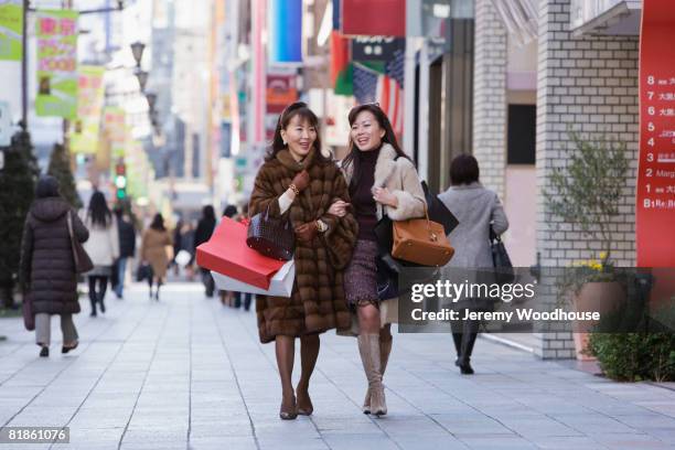 asian women carrying shopping bags - tokyo fashion stock pictures, royalty-free photos & images