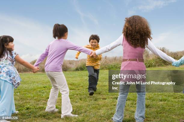 multi-ethnic children playing game in field - asian games day 9 stock-fotos und bilder