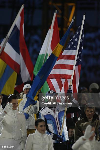 Closing Ceremony: 2006 Winter Olympics, USA speed skating athlete Joey Cheek victorious, carrying USA flag after games at Stadio Olimpico, Turin,...