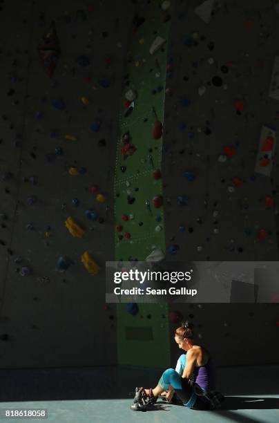 Climber rests between ascents of a climbing wall in an indoor facility of the German Alpine Club Berlin chapter on July 18, 2017 in Berlin, Germany....