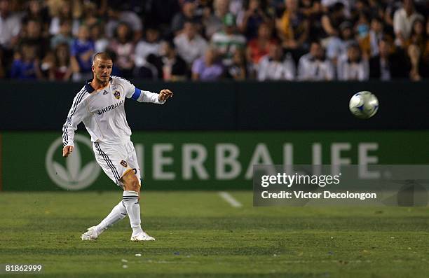 David Beckham of the Los Angeles Galaxy chips a pass to midfield in the second half of their MLS match against the New England Revolution at the Home...