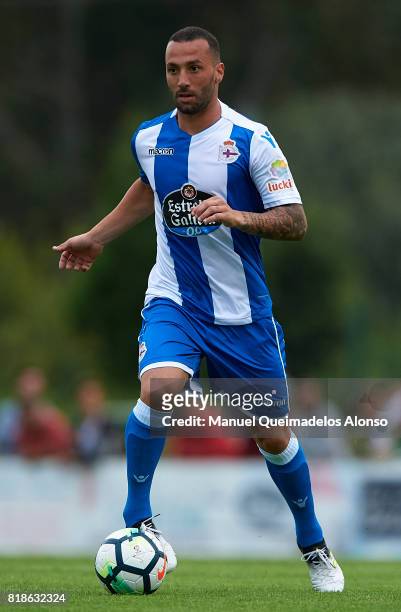 Guilherme dos Santos of Deportivo de La Coruna runs with the ball during the pre-season friendly match between Cerceda and Deportivo de La Coruna at...