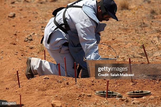 Jordanian de-miners work in a field along the border between Syria and Jordan, on July 08, 2008 near Jaber, Jordan. The National Committee for...