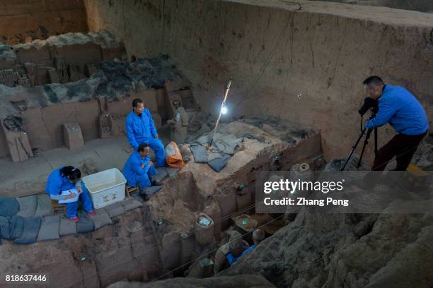 Archaeologists are repairing the terra cotta warriors excavated from the pits. They are exactly the replicas of the imperial guard of Qin shi Huang....