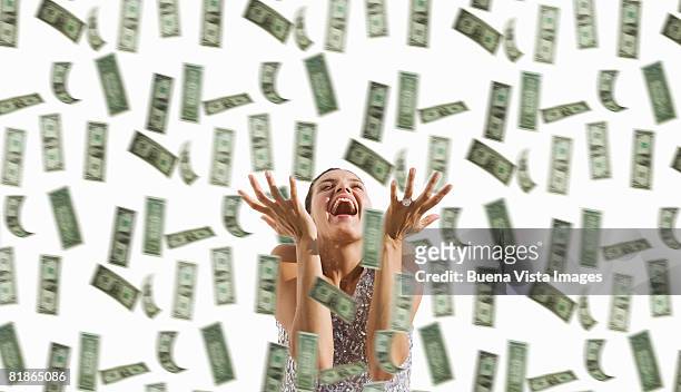 latin woman with falling dollars. - raining money stockfoto's en -beelden
