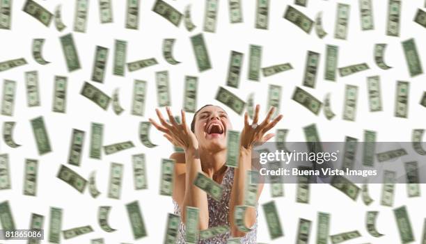 latin woman with falling dollars. - love of money stock pictures, royalty-free photos & images