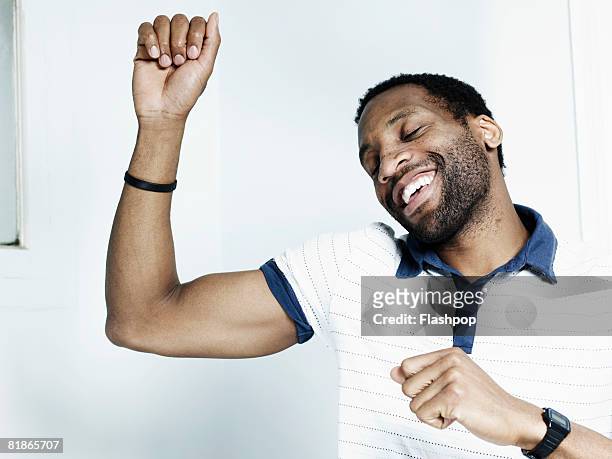 portrait of man dancing - menschlicher arm stock-fotos und bilder