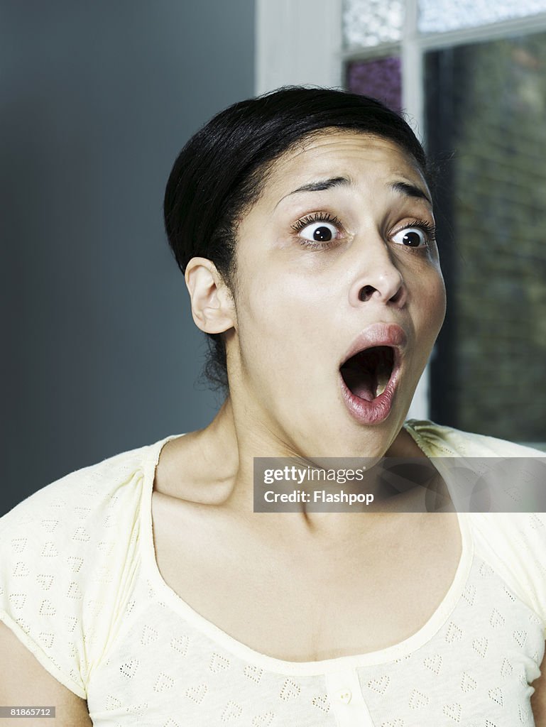 Portrait of woman looking shocked and surprised