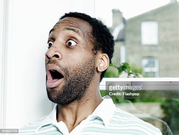 portrait of man looking surprised - shocked stock-fotos und bilder