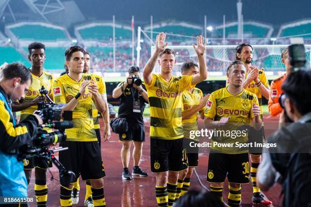 Borussia Dortmund Defender Erik Durm and his teammates interacting with supporters during the International Champions Cup 2017 match between AC Milan...