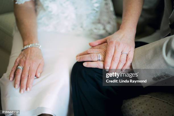 bride and groom hands wearing wedding rings - honeymoon stock pictures, royalty-free photos & images