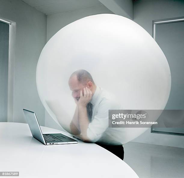 businessman trapped inside a balloon - constraints stock-fotos und bilder