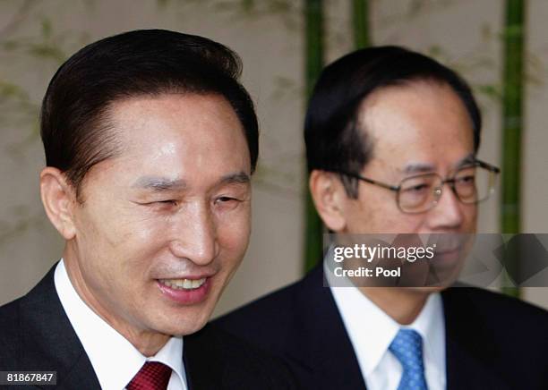 South Korea's President Lee Myung-bak is greeted by Japanese Prime Minister Yasuo Fukuda upon arrival during the G8 Toyako Summit at the Windsor...