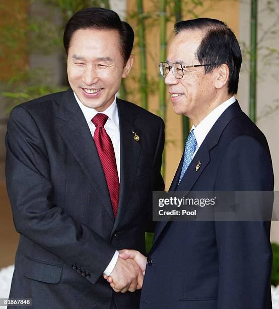 South Korea's President Lee Myung-bak is greeted by Japanese Prime Minister Yasuo Fukuda upon arrival during the G8 Toyako Summit at the Windsor...